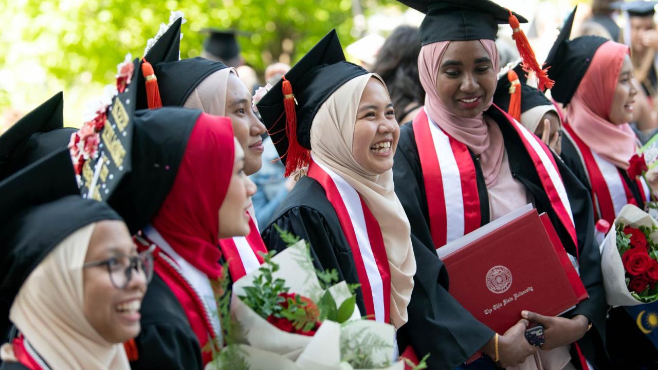 Ohio State graduates standing and smiling